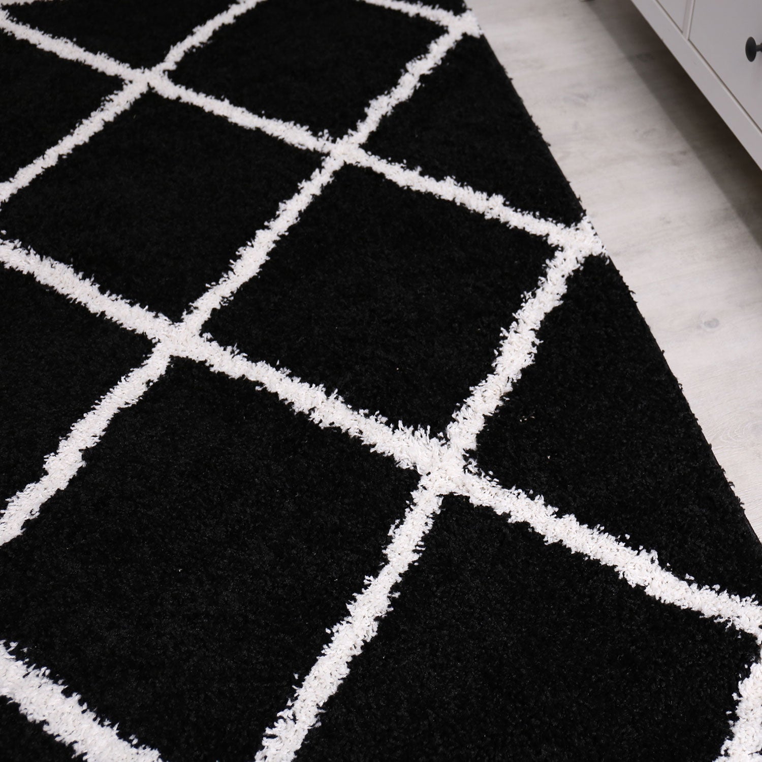 High-pile rug, living room, shaggy diamond pattern, black and cream, Scandinavian design, soft, ethnic