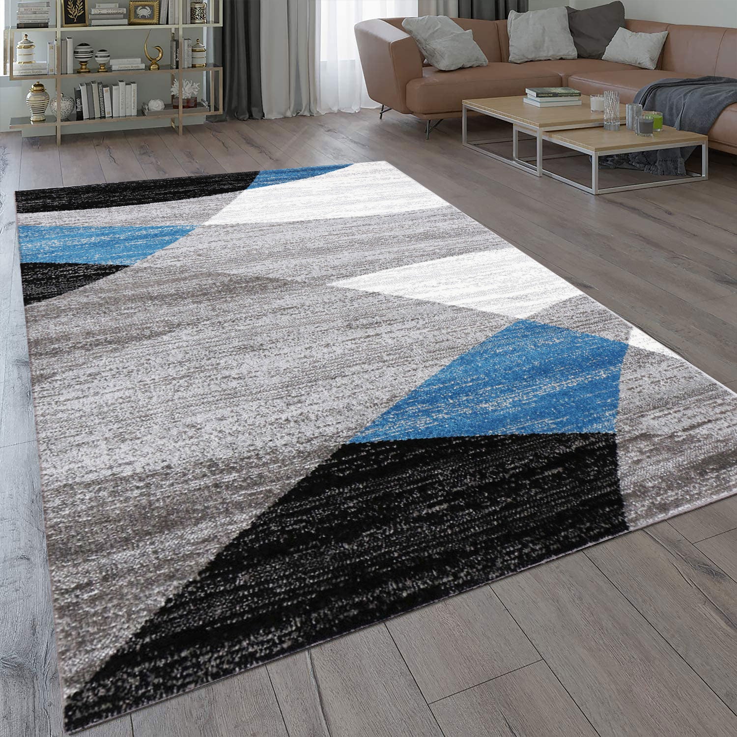 Geometric patterned rug in blue, grey, white, and black, short pile, for living room