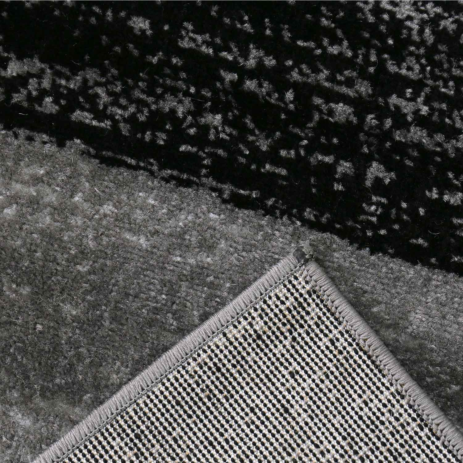 Carpet with geometric tile pattern, mottled checkered in grey, white and black